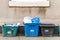 Day view plastice waste refuse bins boxes witn number 48 on British road