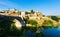 Day view of Puente de Alcantara - ancient bridge in Toledo.