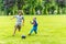 Day view of two boys playing football summer park