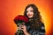 The day of warm feelings and excitement. Young woman smile with fresh flowers. Happy woman hold red roses. Pretty woman