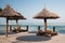 Daybeds with umbrellas on wooden terrace