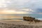 Daybreak over Calm Seas and a Rocky Beach