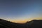 Daybreak at the rim of Mount Ijen with tourists enjoying the sunrise view