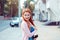 Daydreaming. Happy redhead young girl woman standing outdoor near apartment building looking back smiling happy