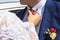 daylight. Bride straightens the groom& x27;s red tie. have toning