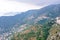 Daylight foggy view to Eze village, trees and mountains from castle