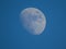 Daylight moon shines bright in evening blue sky over St Andrews