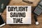 Daylight Saving Time in vintage style light box on office deskt