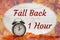 Daylight Savings Fall Back message with alarm clock with fall leaves