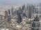 Daylight view of the skyline of Financial district in a megacity with massive buildings and highways. Dubai Metropolis drone shot.