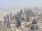 Daylight view of the skyline of a megacity with massive buildings and highways. Dubai Metropolis as seen from the Burj Khalifa.