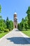 Daylight view to road to cathedral with green trees on side