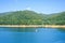 Daylight view to Vidraru lake and Carpathian Mountains with green trees