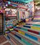 Daytime of stone cafe decorated with multicolored panels colorful stairs, and canopy in Balat District, Istanbul, Turkey