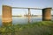 Daytime view of Gateway Arch, grain site for barges and skyline of St. Louis, Missouri at sunrise from East St. Louis, Illinois on