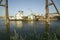 Daytime view of tug boat pushing barge down Mississippi River in front of Gateway Arch and skyline of St. Louis, Missouri as seen