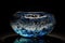 Dazzling dappled lighting: A blue and white molten glass bowl closeup table flame placed in an elaborate icy lake setting