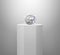 Dazzling diamond on shiny white pedestal podium. concept illuminated pedestal by spotlights on white background