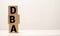 DBA - acronym from wooden blocks with letters, DataBase Administrator or doing business as abbreviation DBA concept