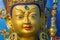 DClose up of gold covered face of tibetan buddhist master Guru Rimpoche.