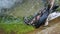 Dead black raven in the clear transparent water of a mountain river.