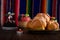 Dead bread and mexican handicrafts with colorful sarape in the background.