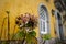 Dead and dying pink Hydrangea flower against a yellow castle wall background