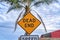 Dead End warning road sign against palm tree in Huntington Beach California