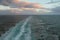 Dead water trace of cruise liner in sea at sunset