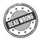 DEAD WRONG text written on black grungy round stamp