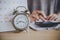 Deadline calendar for taxes payment with alarm clock on desk and blur business woman calculating