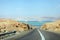 Deadseaview on a curvy sandy road on a highway that runs along the Dead Sea from one side and Edom Mountains at Arava Desert from