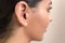 Deaf caused by earphones. close up view of woman`s ear