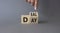 Deal of the Day symbol. Businessman hand points at turned cube with words Deal of the Day. Beautiful grey background. Business and