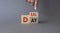 Deal of the Day symbol. Businessman hand points at turned cube with words Deal of the Day. Beautiful grey background. Business and