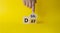 Deal of the Day symbol. Businessman hand points at turned cube with words Deal of the Day. Beautiful yellow background. Business