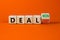 Deal lost or won symbol. Turned a wooden cube and changed words deal lost to deal won. Beautiful orange table, orange background,