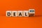 Deal lost or won symbol. Turned a wooden cube and changed words deal lost to deal won. Beautiful orange table, orange background,