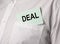 Deal word on paper in pocket of businessman shirt