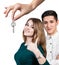 Dealer handing keys to happy young couple