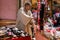 Dealer at the market of Omdurman in a light brown caftan in front of a Stan with shoes made in China slippers and sandals