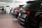dealership car showroom of premium SUVs, cars in a row, rear view