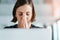 Dear Lord... young businesswoman with hands clasped in prayer while working in an office.