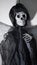 Death, skeleton in black hooded robe