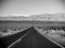 Death Valley, Mojave Desert lone empty road, California, USA: The hottest place on the planet Earth, black and white art photo