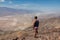 Death Valley - Rear view of man overlooking the Salt Badwater Basin and Panamint Mountains seen from Dante\'s View