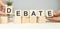 DEBATE word written on building blocks