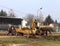 Debowiec/Poland - March 27, 2018: Spring cleaning of green territory in the city. Tractor and excavator for upgrading the green pl