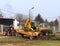 Debowiec/Poland - March 27, 2018: Spring cleaning of green territory in the city. Tractor and excavator for upgrading the green pl