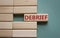 Debrief symbol. Concept word Debrief on wooden blocks. Beautiful grey green background. Business and Debrief concept. Copy space